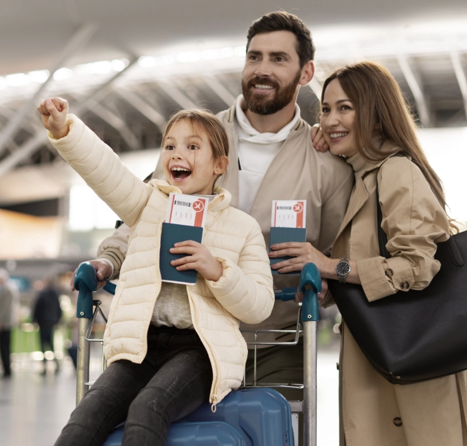 Happy family at airport holding passports and tickets.