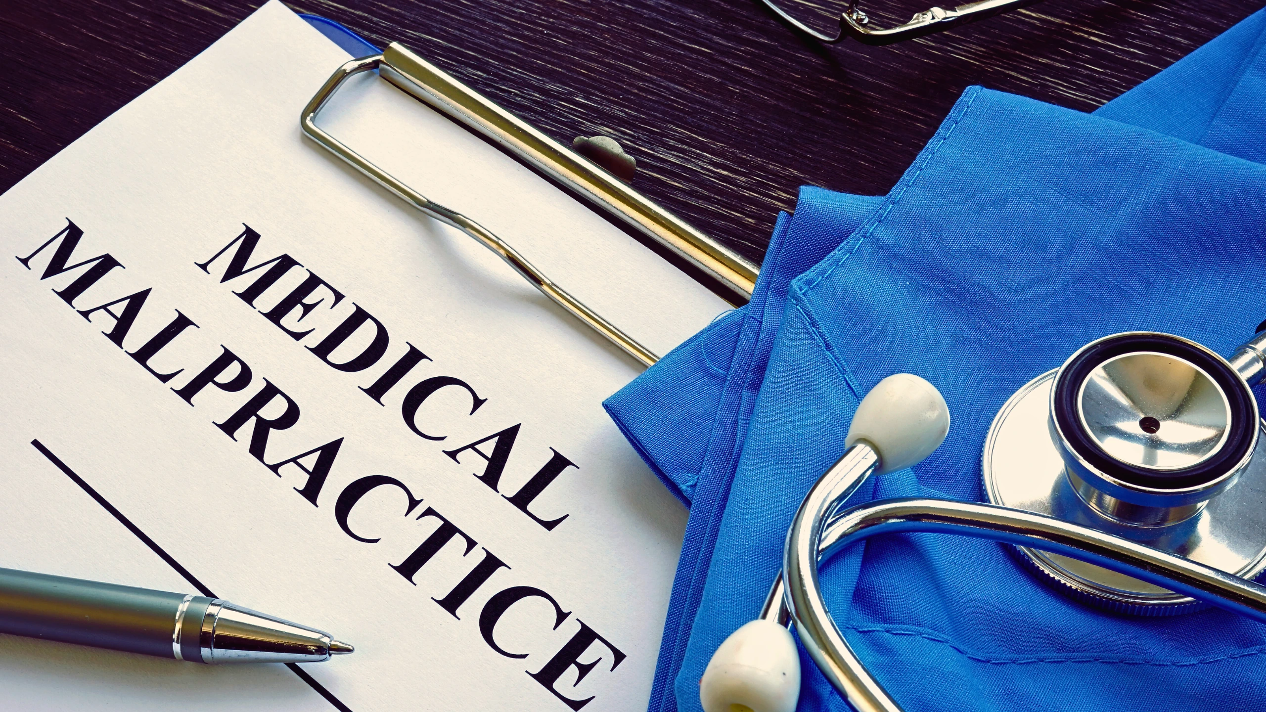 Medical malpractice text written on a paper.