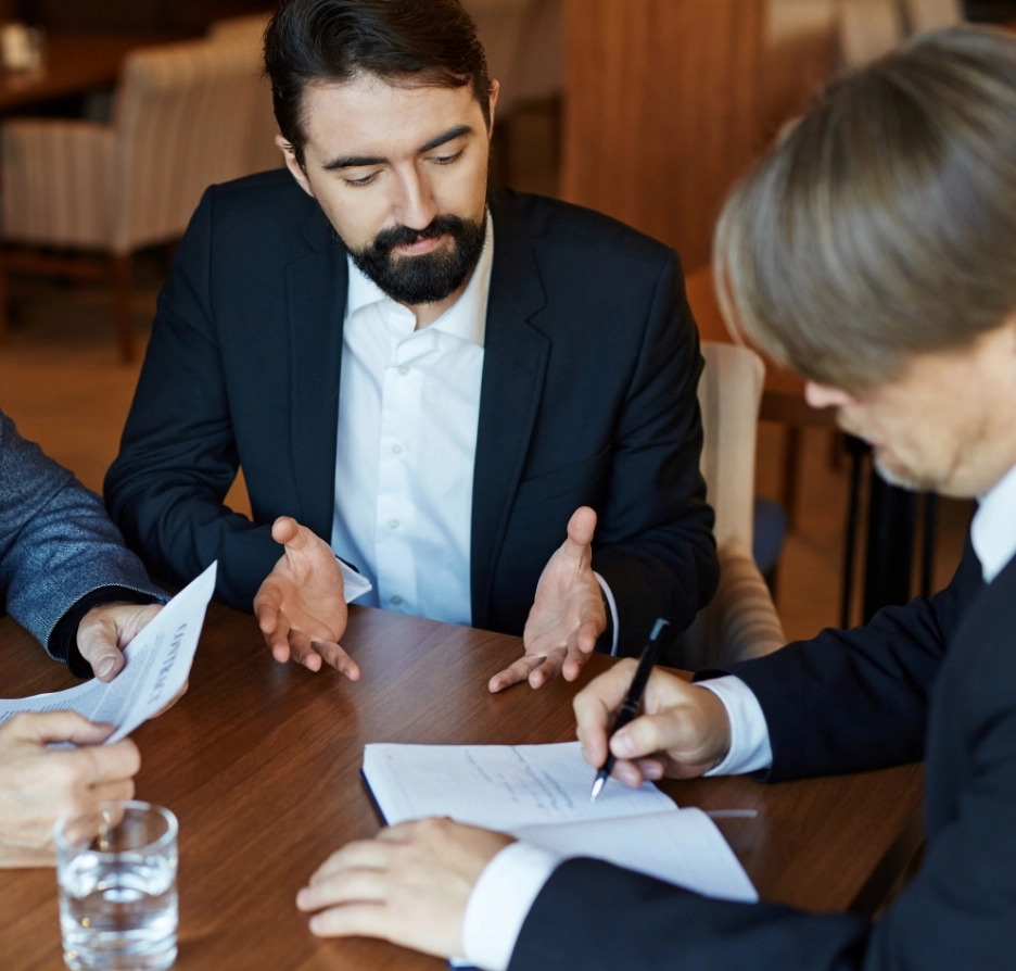 A man in a suit discusses a contract.