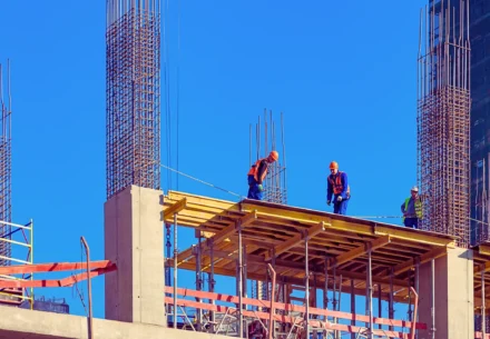 Construction workers working on a high building.