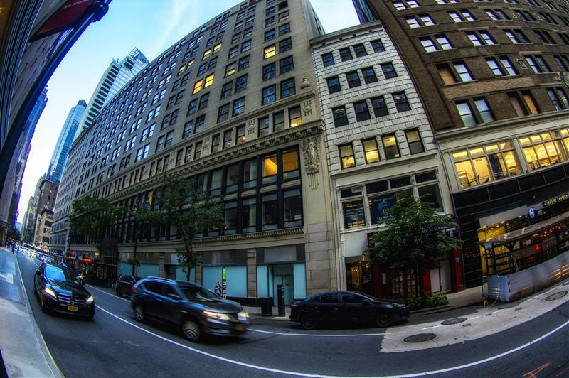 A silver revolver handgun resting next to a white concealed weapons permit card.