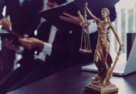Lady justice with a team of lawyer on the background.
