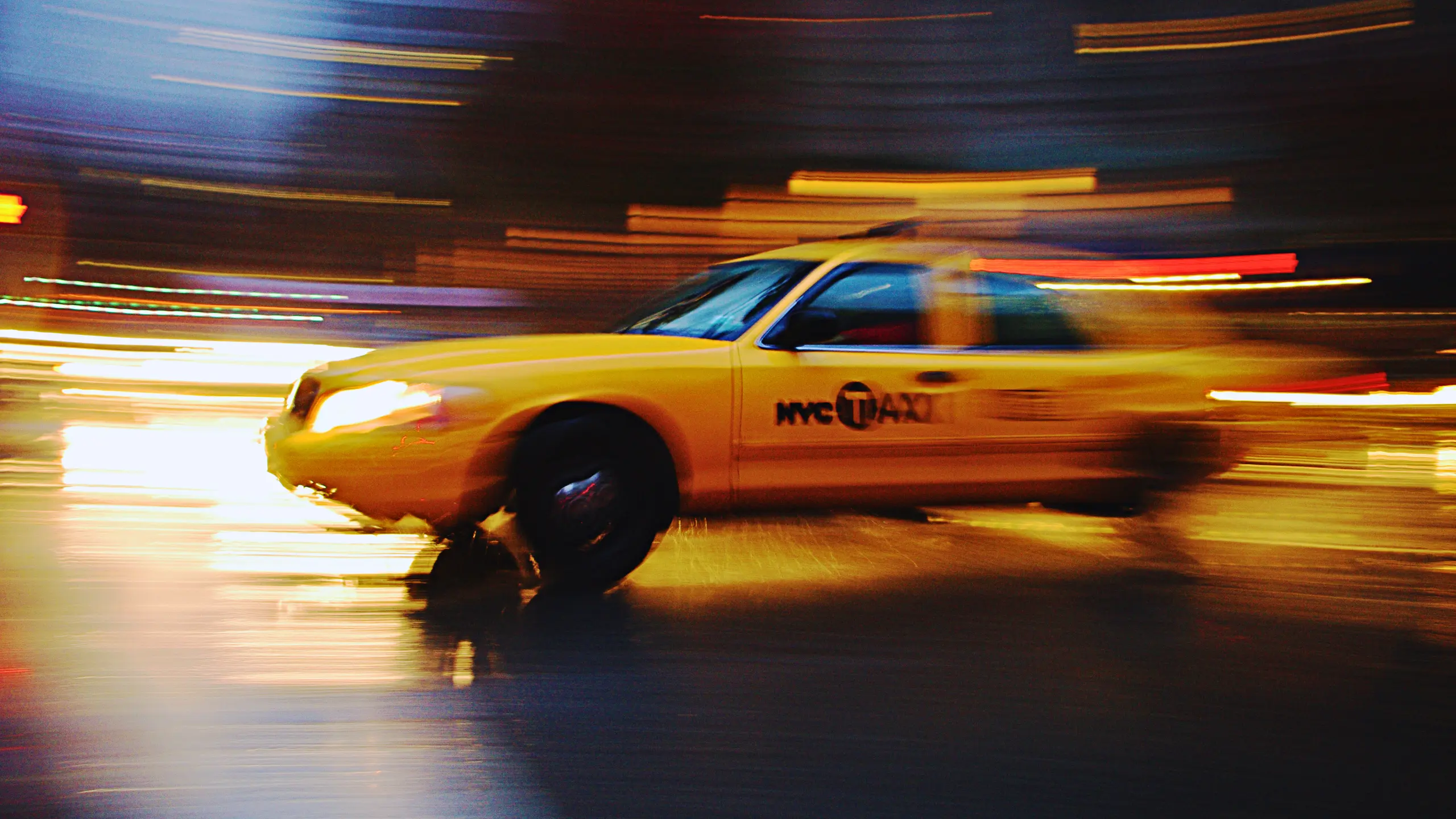 Justice For Manhattan Pedestrian Hit By Taxi 1 Rushing taxi with city lights background.