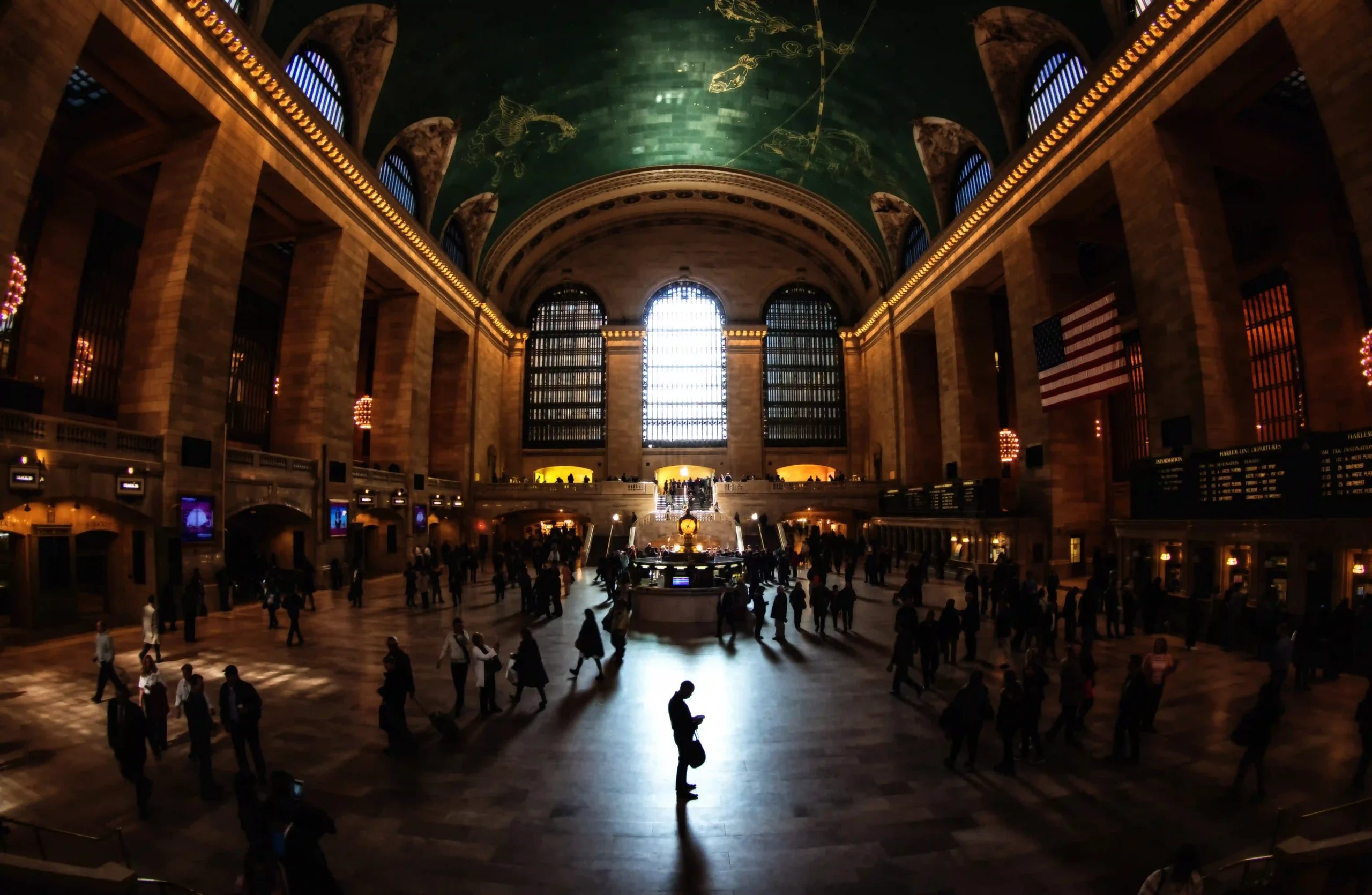 Busy Grand Central Terminal hall with crowds walking under its iconic arched ceiling.