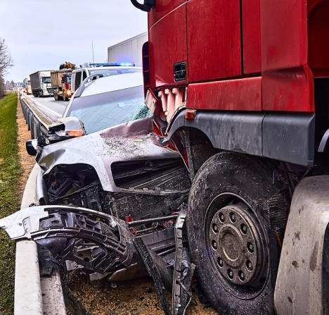 Severe car and truck collision on a highway.