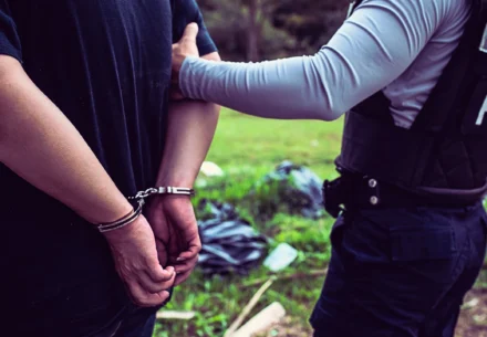 Criminal being arrested by cops.